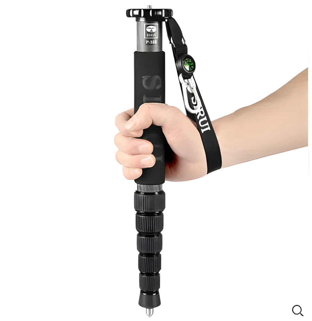 Black carbon fibre SLR camera monopod extended to full height with six sections visible