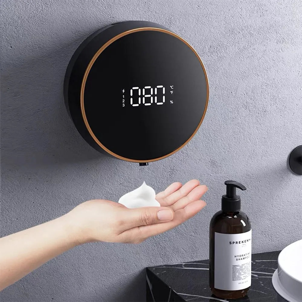 Black smart sensor foam soap dispenser mounted on a bathroom wall.