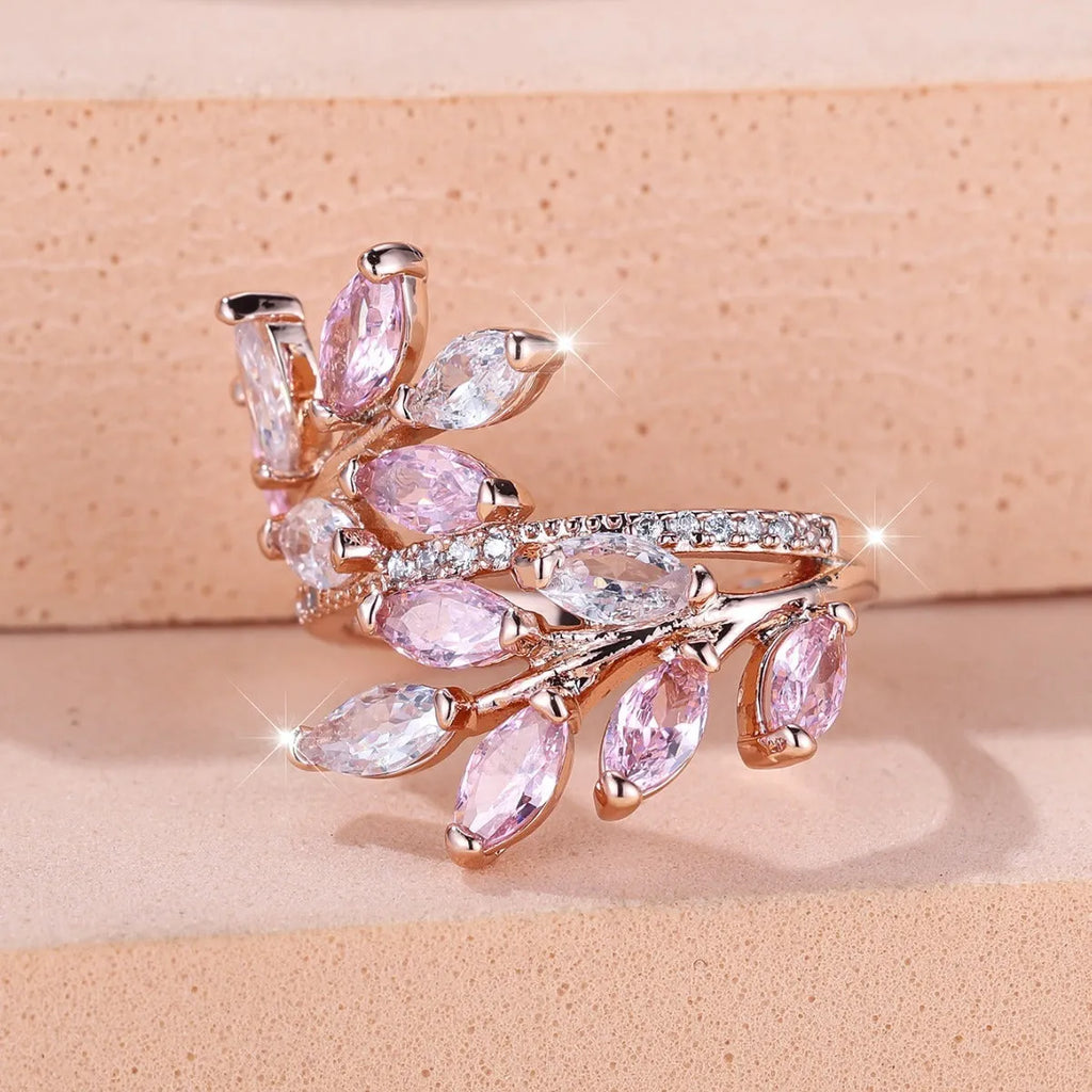 Adjustable copper leaf ring in platinum or rose gold finish on a white background
