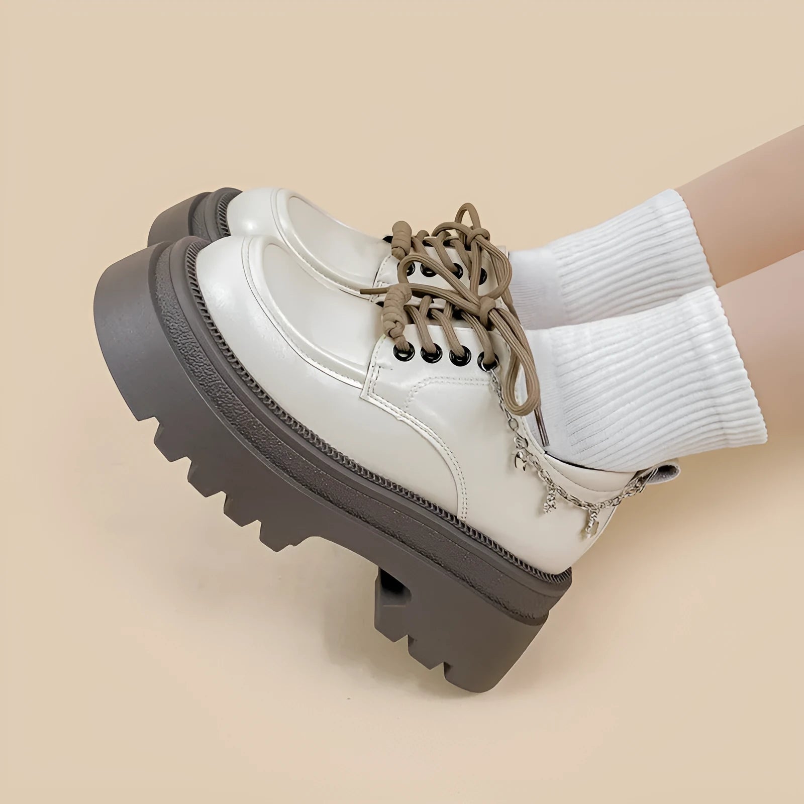 White platform Mary Jane shoes with chunky heel and front lace-up, featuring XINGX bear design.