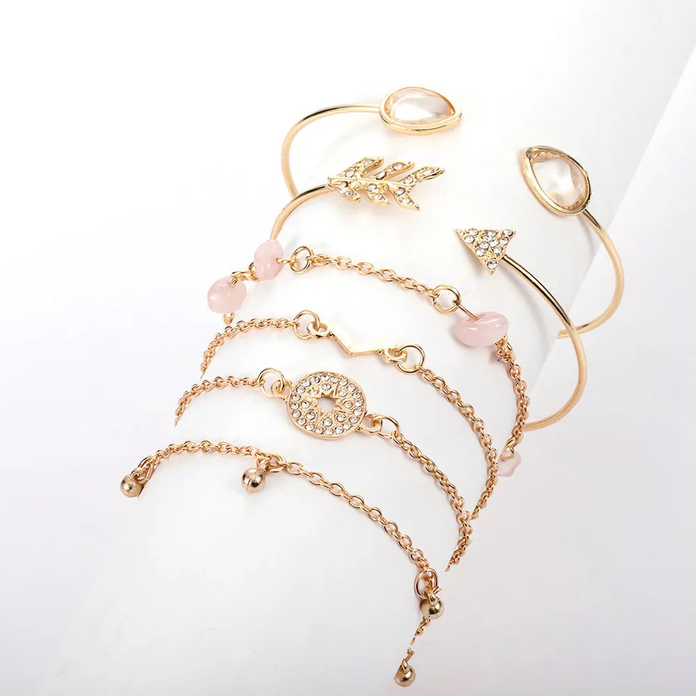 Gold six-piece bracelet charm set with V-shaped, arrow, water drop, and spot drill designs on zinc alloy