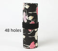 Rolled-up canvas pencil case with ballet girl print, showing multiple pencil slots.
