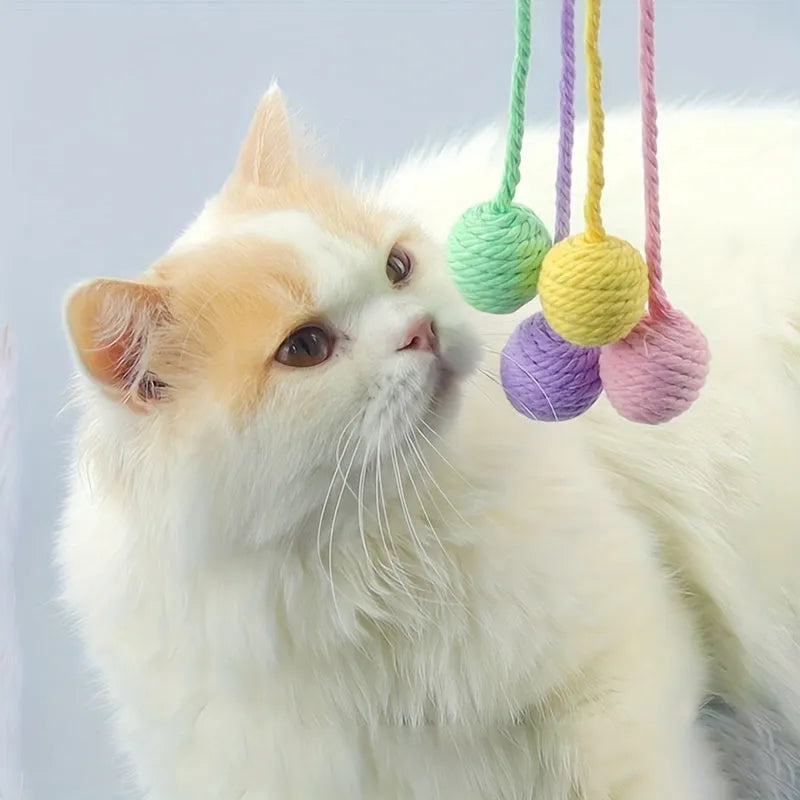 Cat toy ball with rope and bell inside in green, pink, purple, and yellow colours