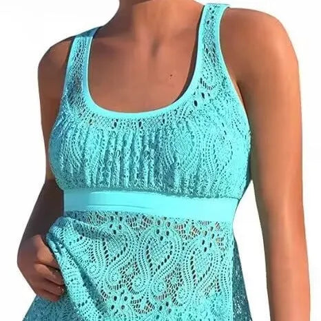 Women's solid colour two-piece swimsuit with sleeveless top and briefs, made from nylon fabric.
