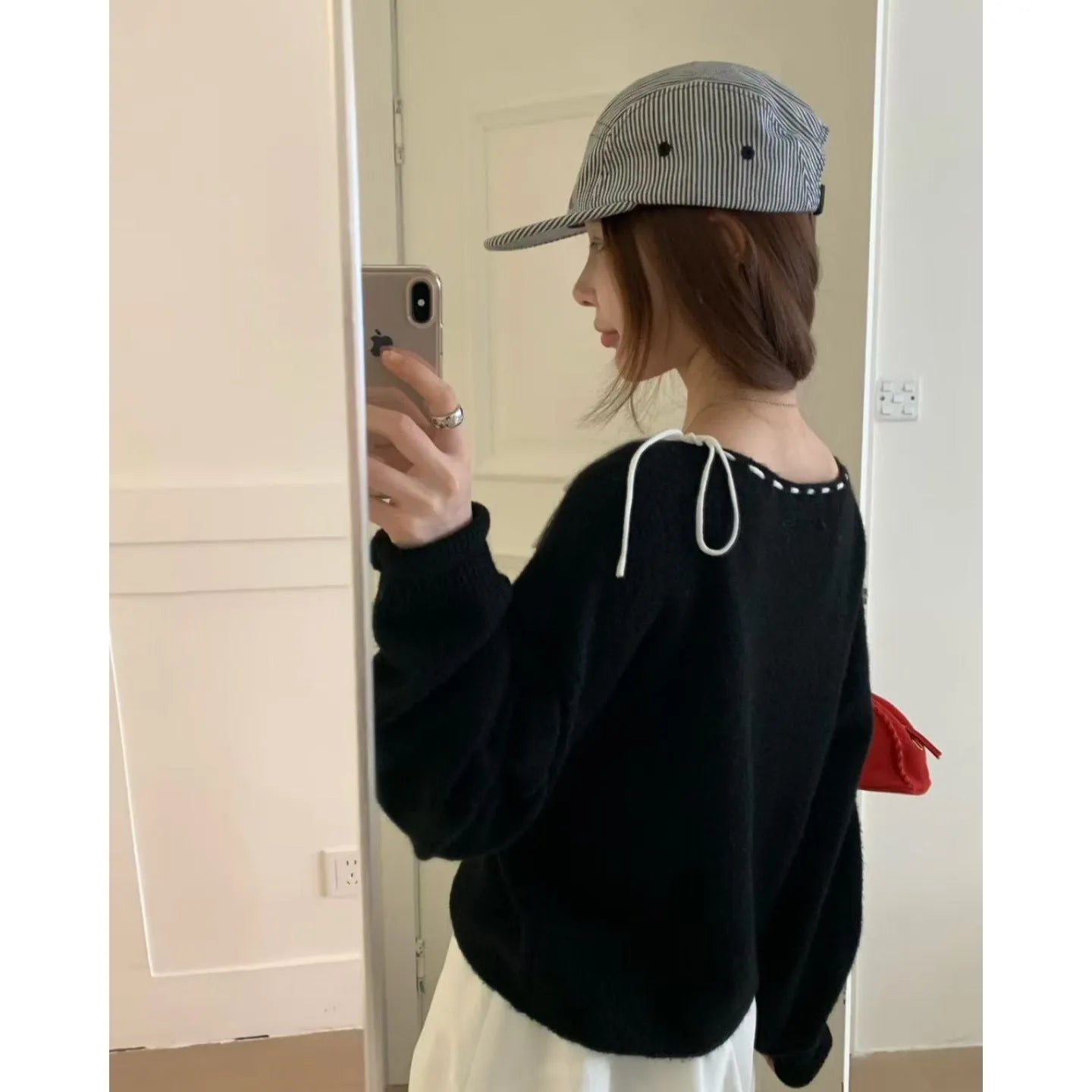 Women's loose grey knitwear pullover jumper on a hanger