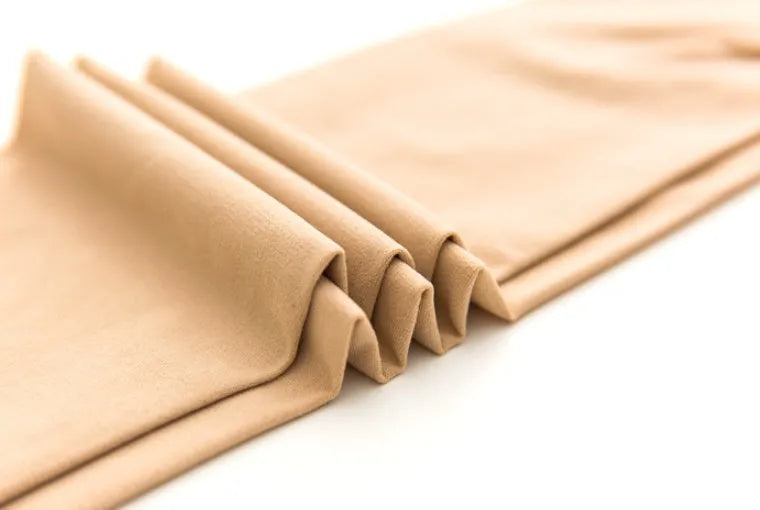 Beige and black stovepipe socks made from polyester for lifting hips and abdomen, shown in one-size fit.
