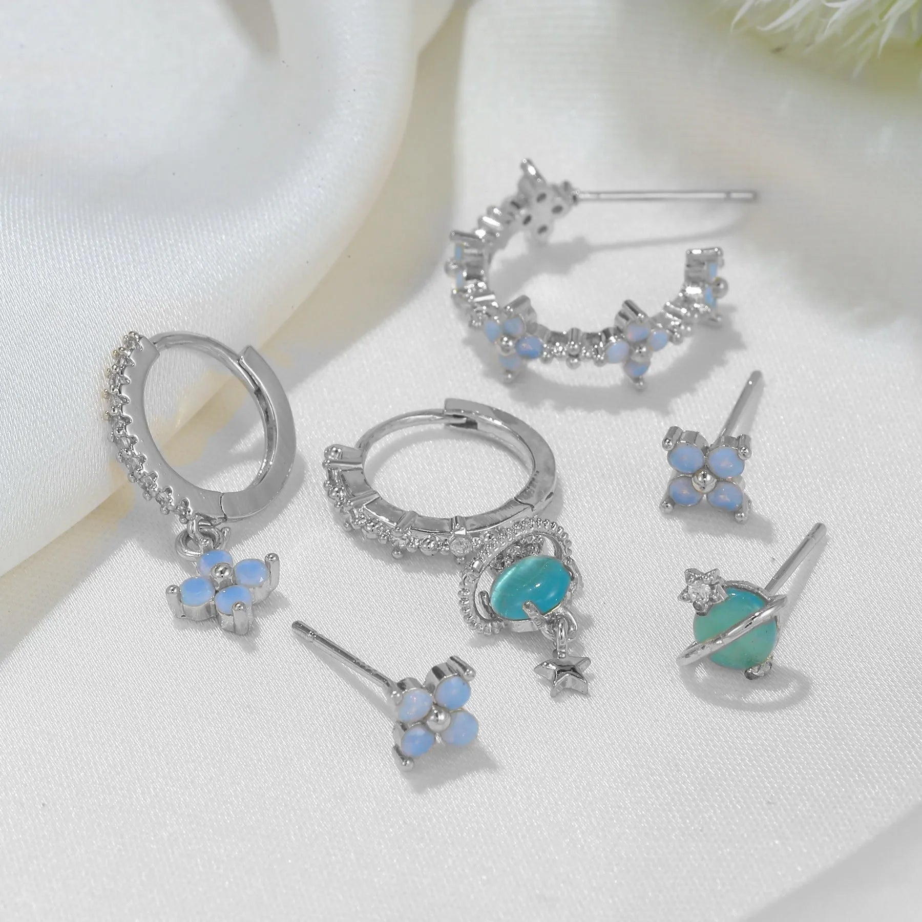 Gold and silver floral ear studs with zircon mosaic stones and geometric metal design