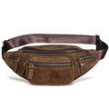 Brown leather messenger bag with a single shoulder strap shown open on a table