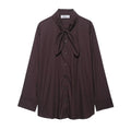 Brown women's poplin shirt with long sleeves, a loose fit, and a bow tie front closure.