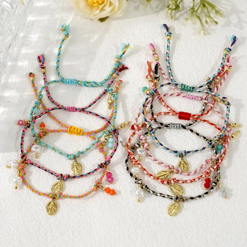 Ethnic style hand-woven bracelet made from colourful braided rope on woman's wrist