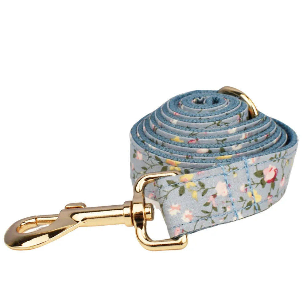 Blue floral pattern dog collar made from polyester cotton fabric with adjustable strap and decorative bow accessory.