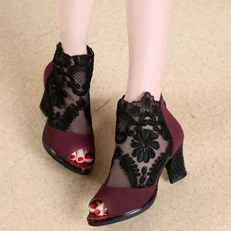Women's black lace gladiator sandals with square heels and zip closure showing flower detailing