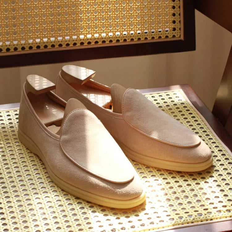 Men's brown genuine leather handmade loafers with a flexible TPR sole on a white background.