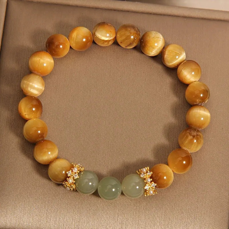 Natural yellow tiger's eye Hetian jade bracelet in u-shaped design with auspicious patterns.