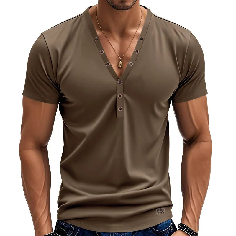 Man wearing a loose fit solid colour V-neck pullover top with a small button design detail.