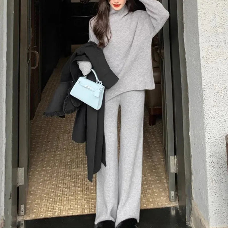 Women's beige casual sweater and wide-leg pants two-piece set on a hanger.