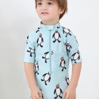 Boy's penguin print long sleeve swimsuit with matching swimming cap set on white background