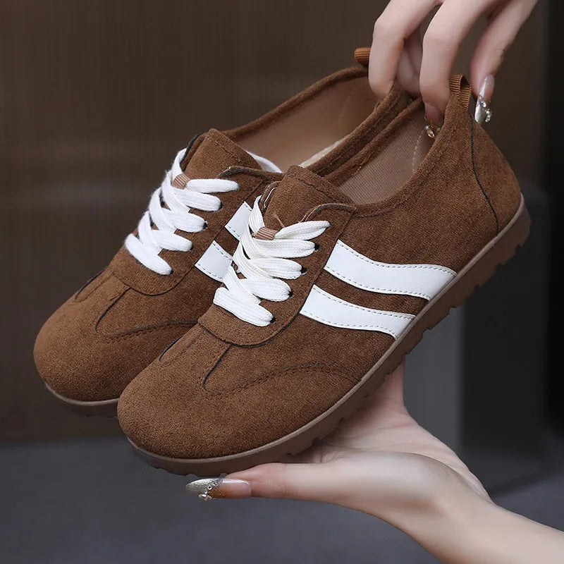 Women's dark red canvas sneakers with a flat rubber sole and round toe on a white background.