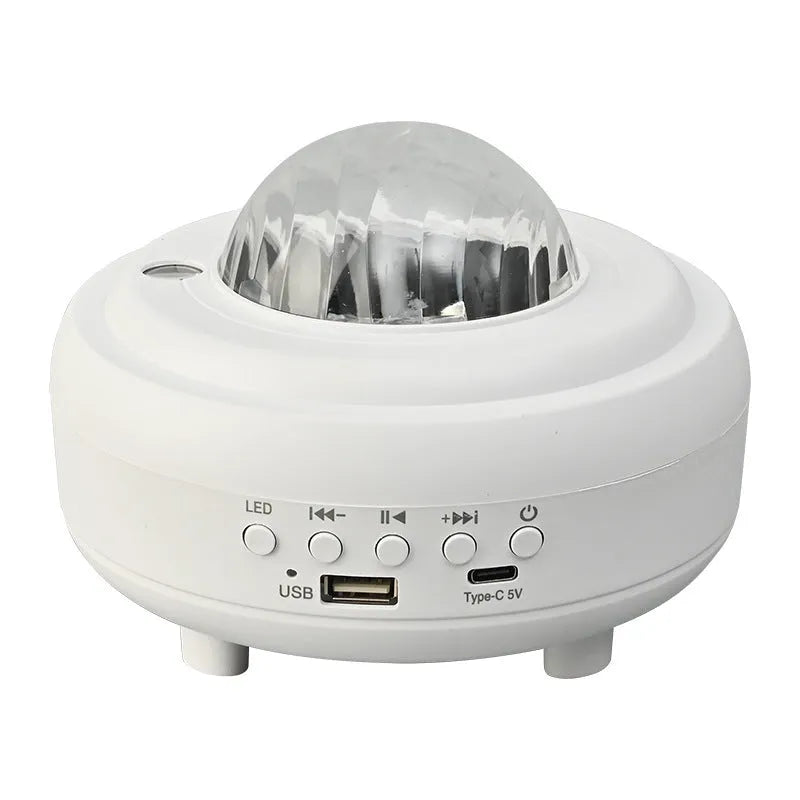 White galaxy star projector night light with Bluetooth speaker showing star projection on wall