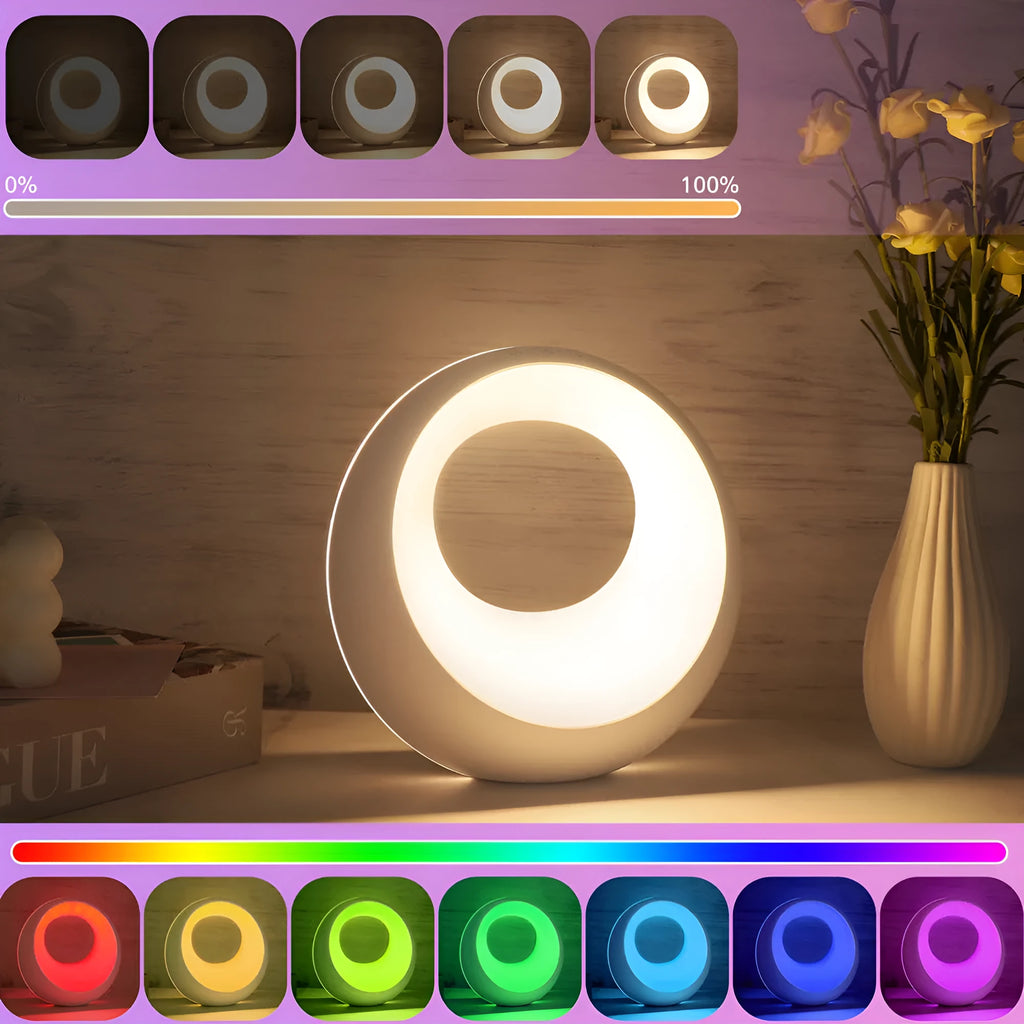 Small creative touch RGB colour changing desk lamp with remote control on a wooden surface