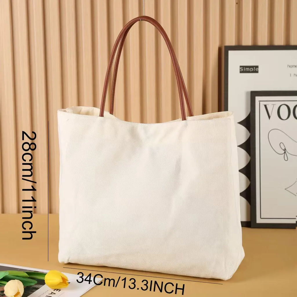 Beige white canvas tote bag with reinforced cotton handles and a flat base.