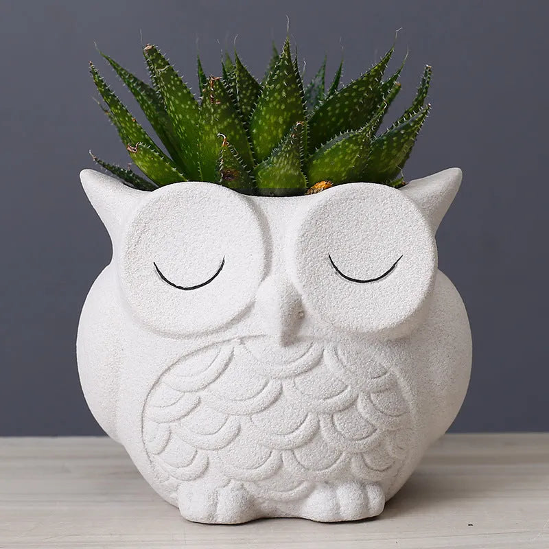 Handmade frosted ceramic succulent pot with cartoon owl design, shown in light pink.