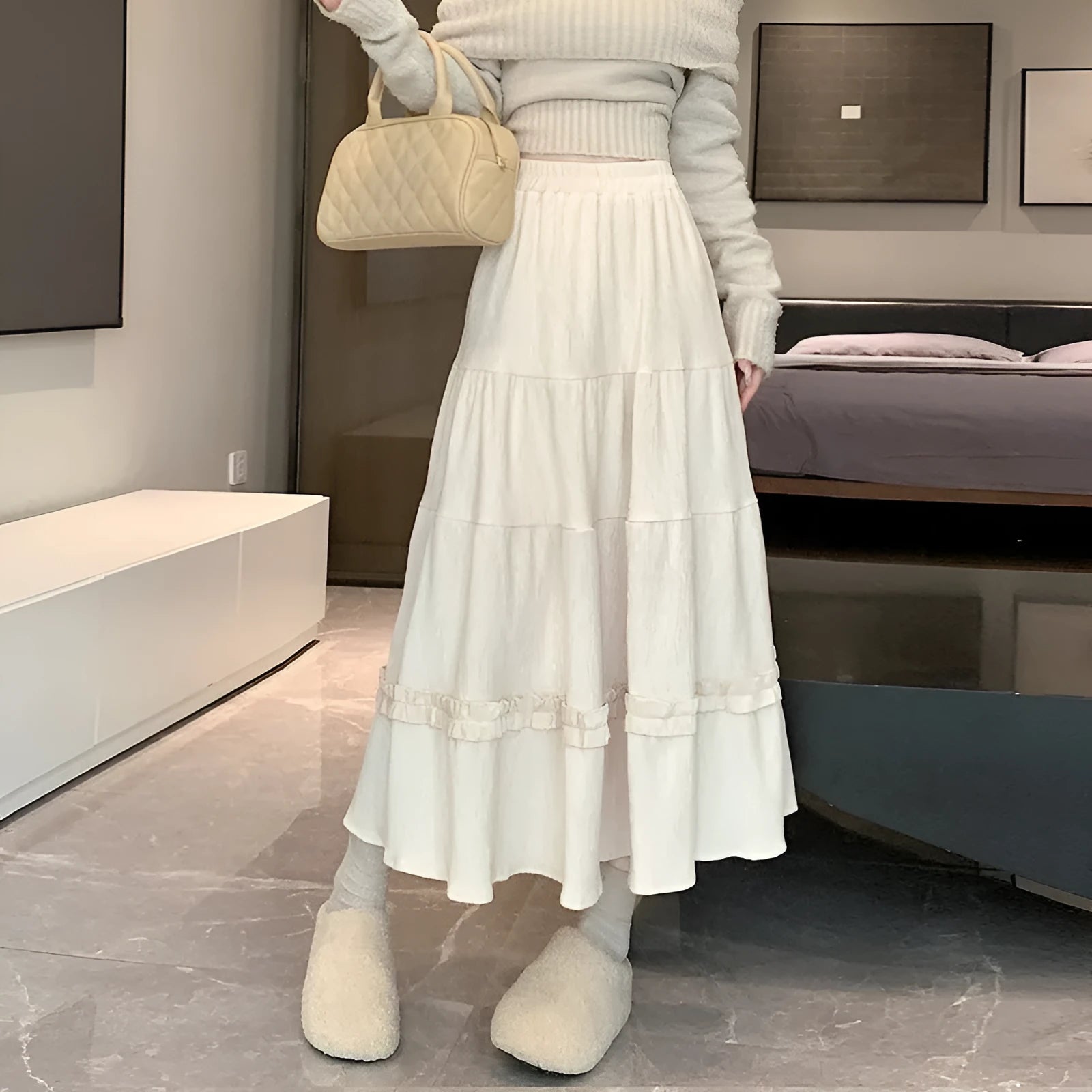 Korean style corduroy A-line midi skirt with elastic waistband in milky white, shown on a model.