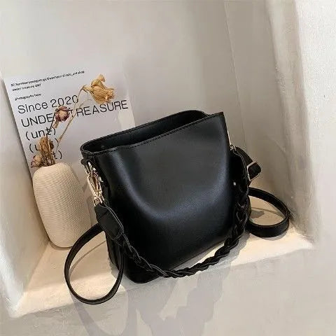 Retro unisex brown PU bucket bag with woven detail, shown with crossbody strap.