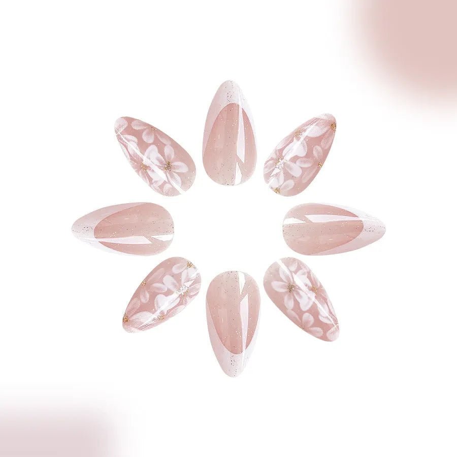 Removable short almond nails with French style finish and glitter flower decoration in colour C625