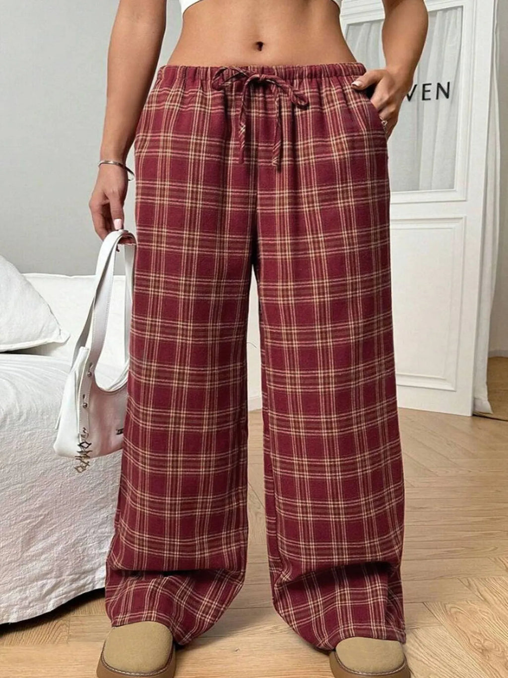 Women's red plaid casual trousers with drawstring waist and patch pockets laid flat