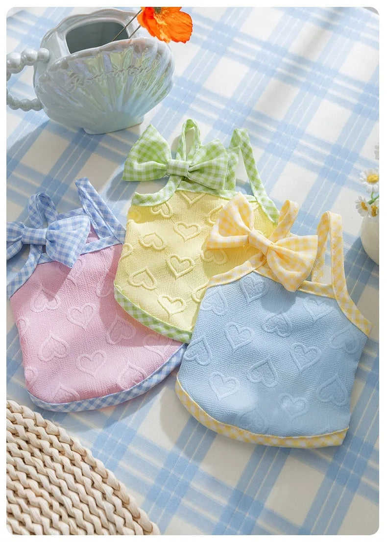 Small dog wearing heart texture bow suspenders vest in elastic material