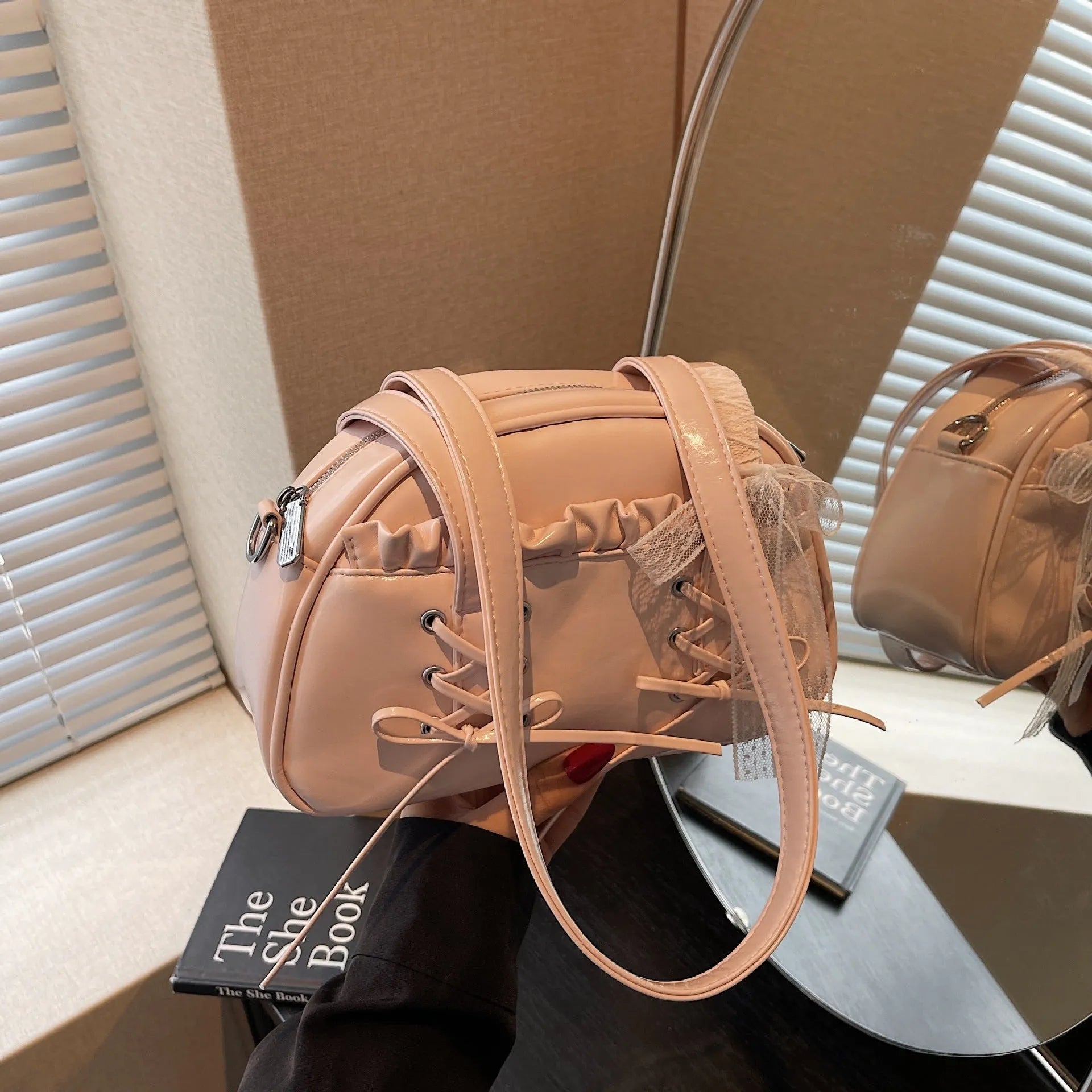 Women's casual shoulder handbag with bandage bow detail in PU material showing internal phone compartment