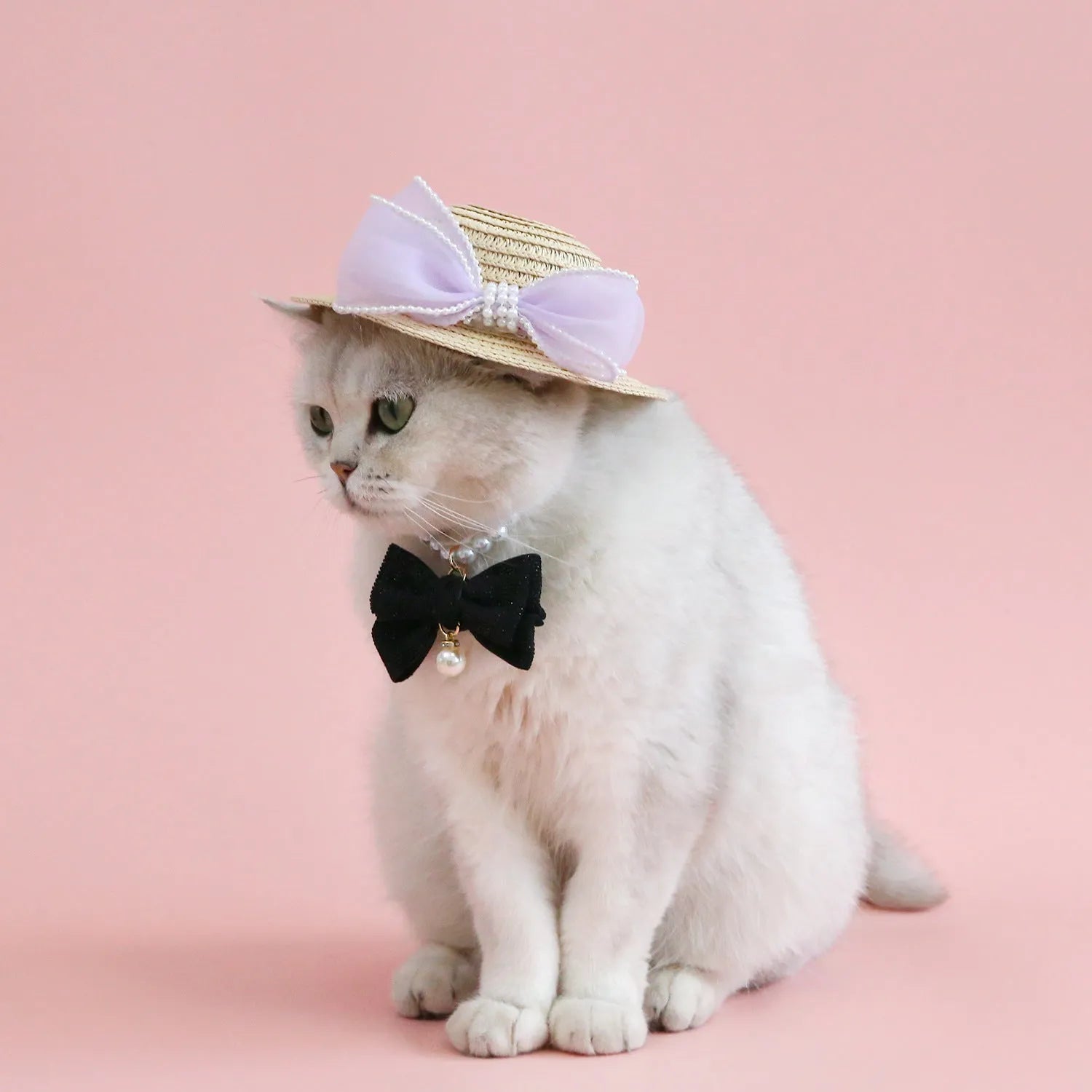 Pink pearl butterfly bow woven straw hat for a cat on a mannequin head.