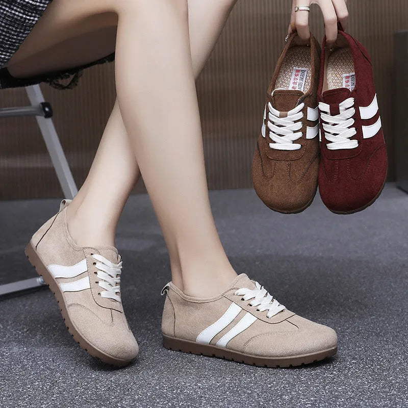 Women's dark red canvas sneakers with a flat rubber sole and round toe on a white background.