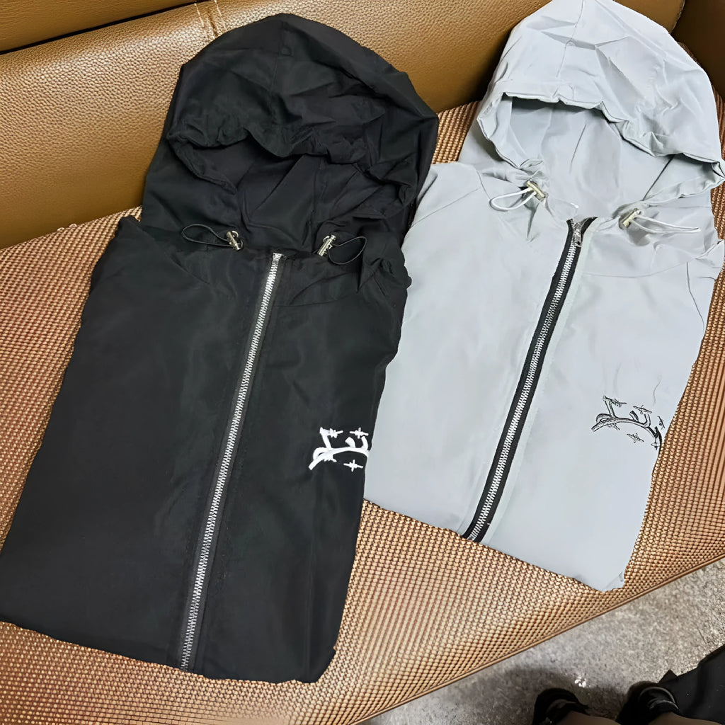 Grey loose fit men's hooded sunscreen jacket in British style on a middle-aged model.