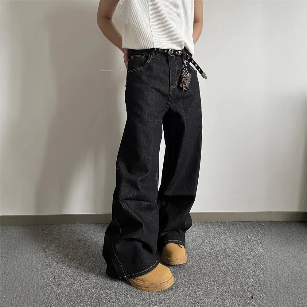 Black loose wide-leg straight-leg retro jeans on a hanger, showing zip fly and mid waist.