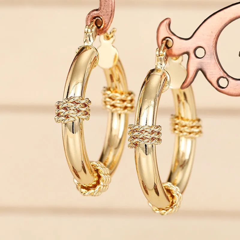 Geometric copper clip-on earrings for women with ring and line design in a golden finish.