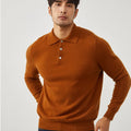 Man wearing a sapphire blue loose-fit cashmere polo collar pullover sweater.