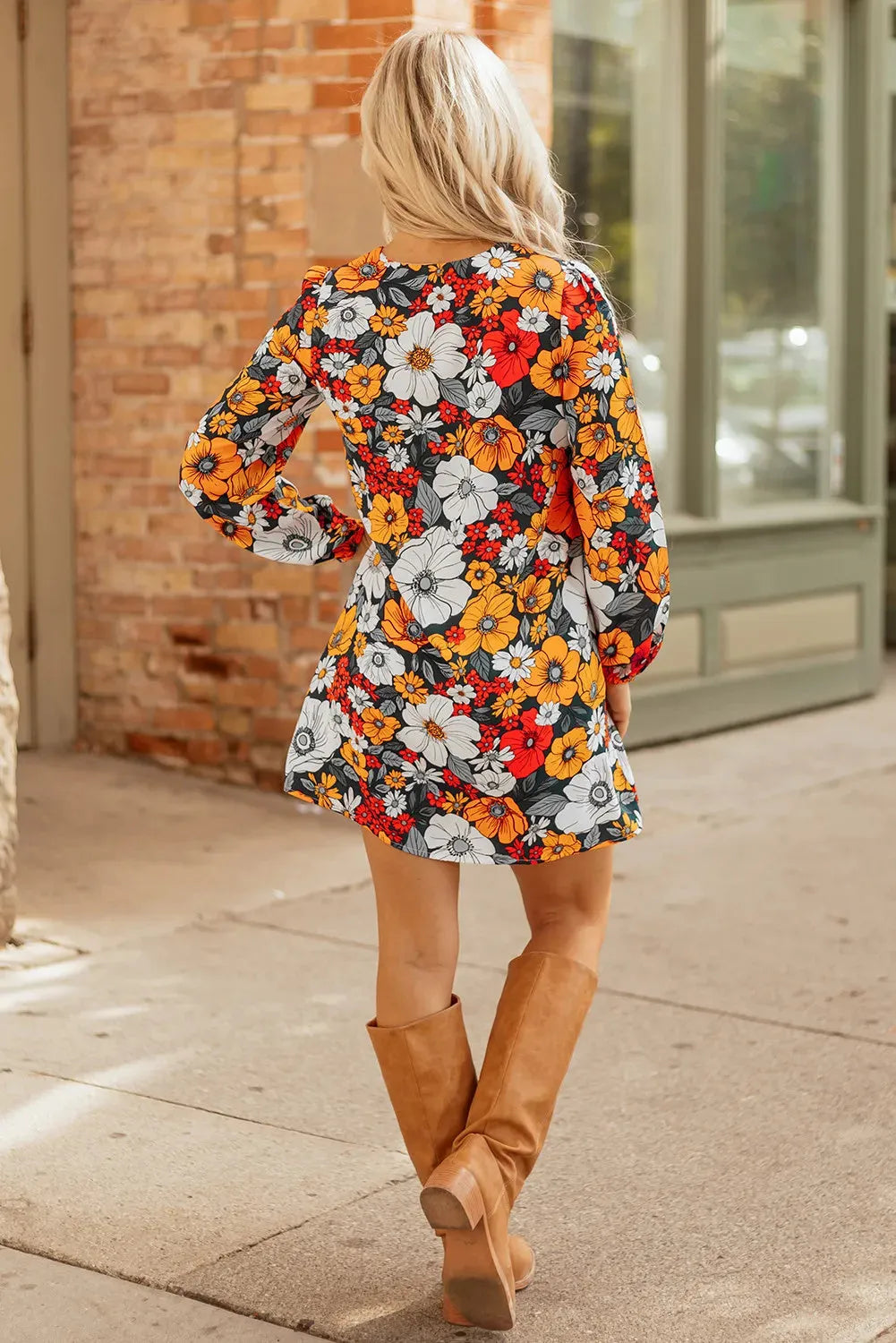 Orange floral print V-neck mini dress with long lace sleeves on a mannequin.