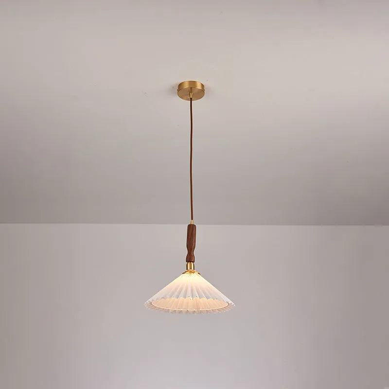 American retro rubber wood and fabric wall lamp in walnut finish on a wall.