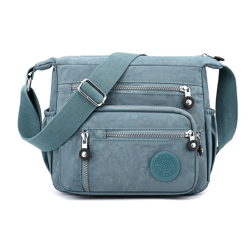 Nylon messenger bag with square vertical shape and single shoulder strap in available colours