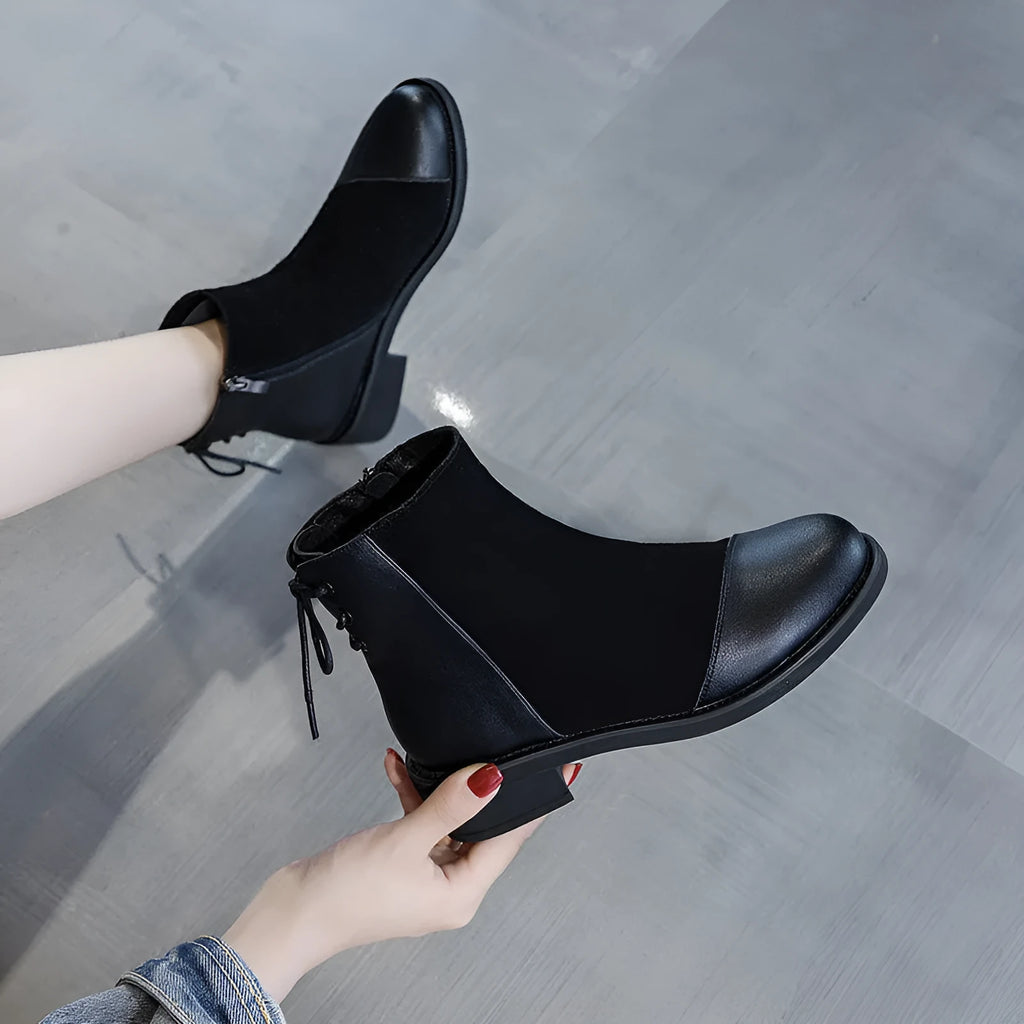 Women's black Martin boots with side zipper, round toe, and knee-length design