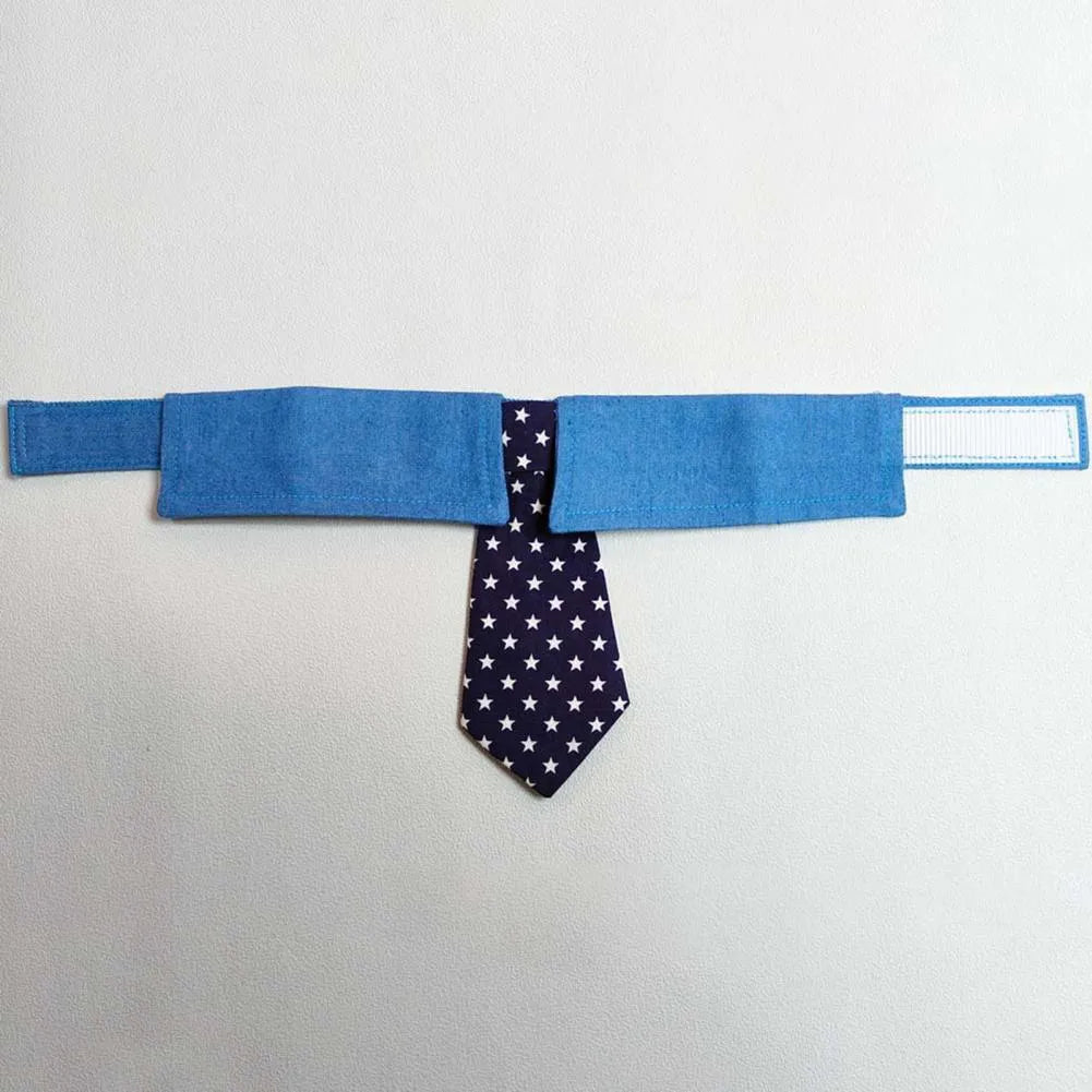 Denim dog collar with an attached red star pattern necktie, showing the adjustable fastener tape closure.