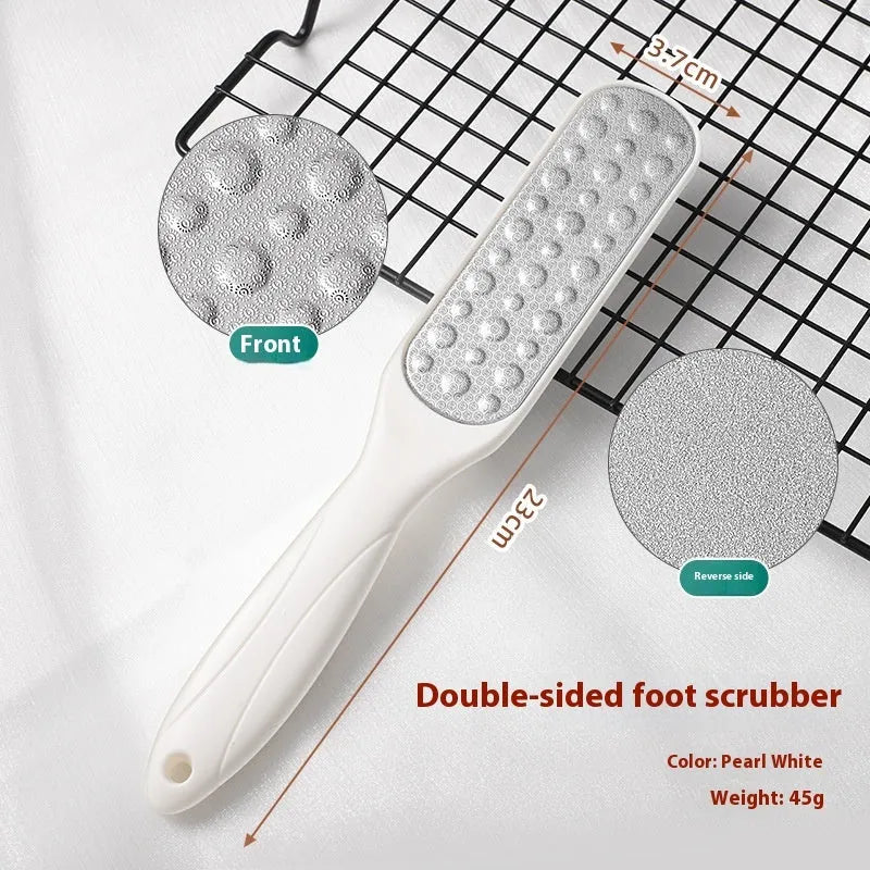 Stainless steel foot grinder tool with white and black double-sided abrasive files for callus removal.