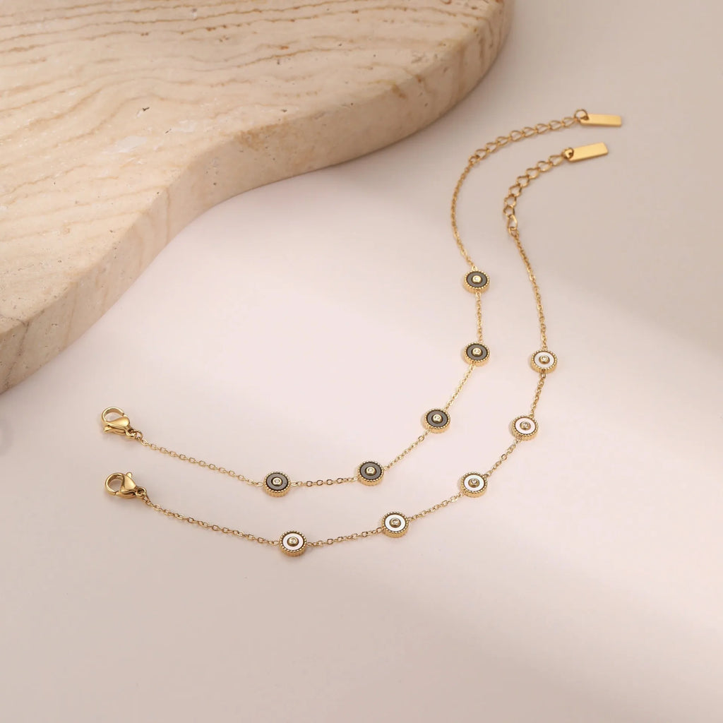 Stainless steel bracelet and necklace set with 18K gold plating and geometric fritillary design