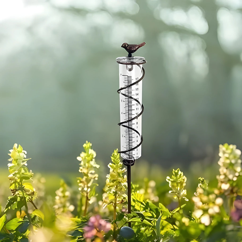 Cast iron garden rain gauge with hummingbird decoration showing 1-20 scale markings