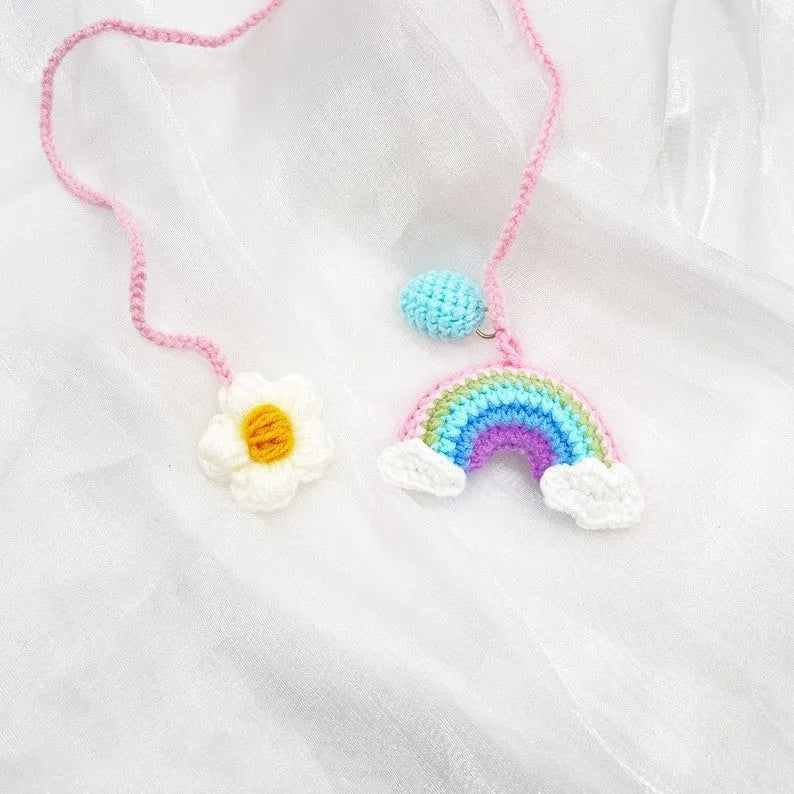 Handmade crocheted avocado-shaped and rainbow pattern car pendants made from wool yarn.