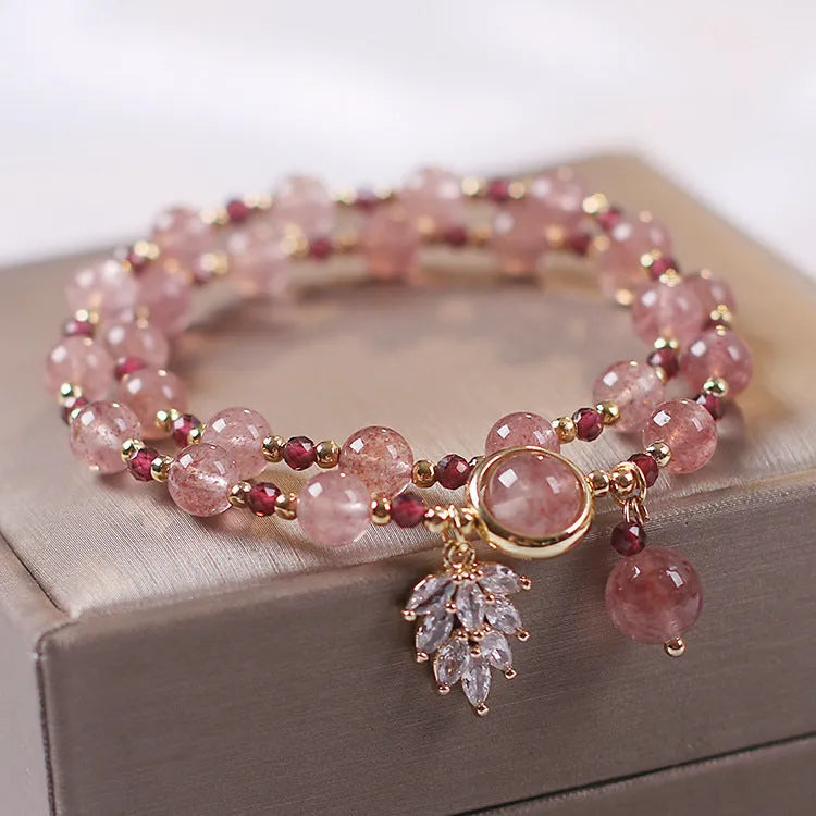 Women's double layer crystal bracelet with lucky cat charm and red cat's eye flowers.