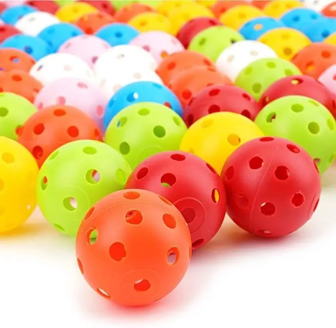 Multi-colour golf practice balls showing red, orange, blue, green, white and yellow variants with 26-hole design