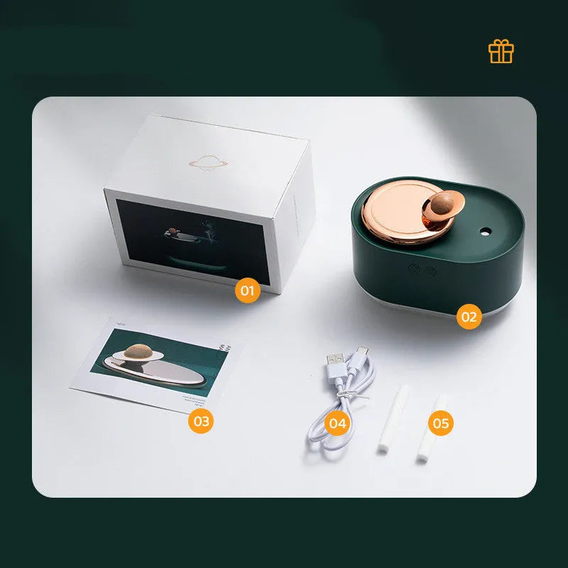 Green rotating planet-shaped desktop humidifier with night light on a wooden table.